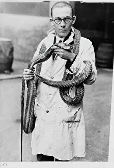 Scaled: Man wearing snake, 1930s