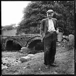 Packhorse: Man, wearing traditional clogs, Packhorse Bridge at Wycoller