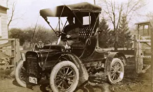 Steering: Man at the wheel of an early car, USA