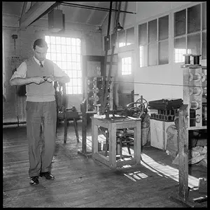 Leek: A man winding a reel of silk by hand