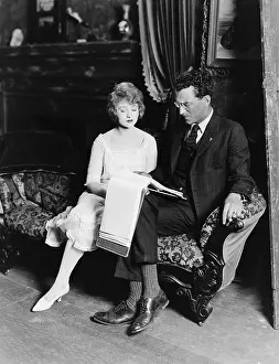 Couches: Man and woman on couch with paperwork