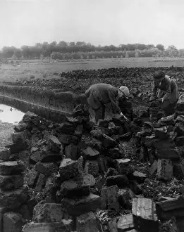 Decayed: Man and woman digging for peat, Ireland