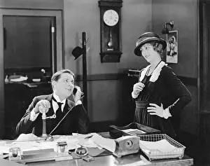 Coquettish: Man and woman flirting in the office