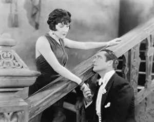 Formalwear: Man and woman holding hands and looking at each other