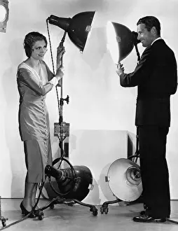 Interactions: Man and woman with lights on stands