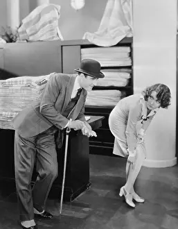 Bowlers: Man with woman pointing at run in stocking