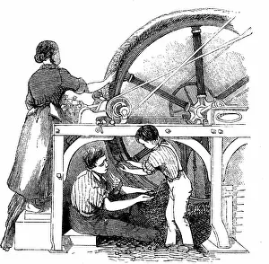 Fleece: Man, woman & small boy working wheel for combing