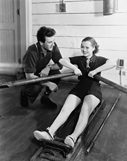 Rower: Man with woman using rowing machine