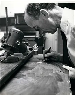 Fingerprints: Man at work with microscope, Scotland Yard, London