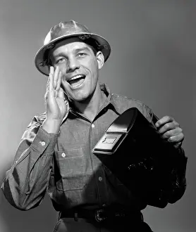 Yell: Man worker in hard hat yelling carrying lunch