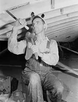 Chisel: Man working with a chisel on a beam of a motor