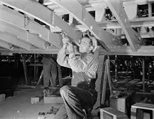 Chisel: Man working with a chisel on a beam of a motor