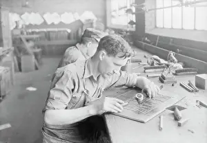 Tennessee: Man working at Kingsport Press building up a case, 1933