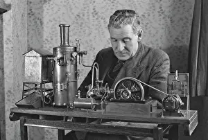 Hobbyist: Man working on miniature steam engine