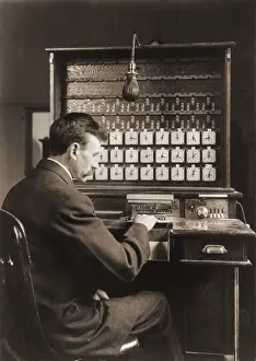 Computation: Man working with punch cards in an early ?