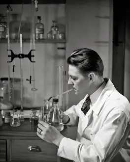 Labs: Man Working in Science Laboratory Pipetting Liquid