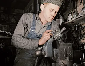 Clamp: Man working in a small machine shop for war