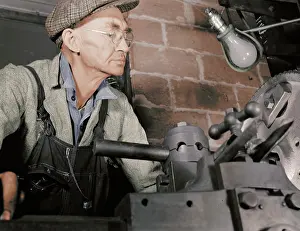 Bulbs: Man working in a small machine shop for war