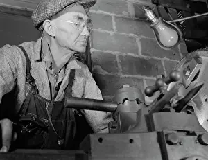 Bulbs: Man working in a small machine shop for war