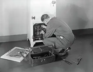 Refrigeration: Man workman fixing refrigeration machinery of