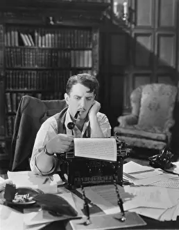 Compositions: Man writing first draft on a typewriter