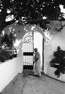 The Japics Historic Image Collection: Man at a wrought iron gate, Spain