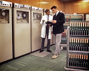Silos: Manager and Technician Standing Together Checking a Manual