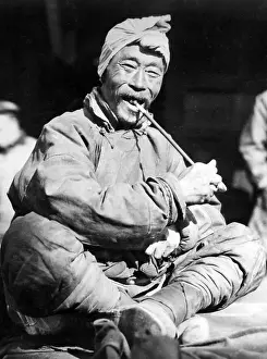 Manchuria: Manchurian peasant smoking pipe, ca. 1931