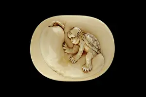 Netsuke: Manju netsuke - a kappa sitting on a cucumber