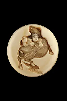 Netsuke: Manju netsuke - an ox-herd trying to mount his ox