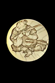 Sharpness: Manju netsuke - a samurai testing the sharpness of his sword