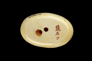 Shishi: Manju netsuke with a shishi playing with a ball