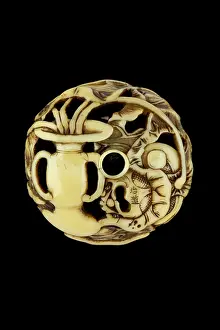 Shishi: Manju netsuke with silver shishi with ball