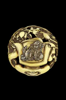 Shishi: Manju netsuke with silver shishi with ball