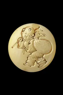 Netsuke: Manju netsuke - a small boy carrying Hotei's sack