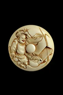 Puffer: Manju netsuke - smiling priest about to prepare puffer fish