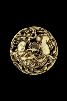 Netsuke: Manju netsuke with tennin and lotus flower in clouds