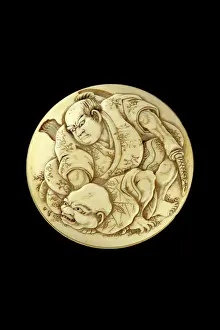 Netsuke: Manju netsuke - a warrior slaying a bakemono