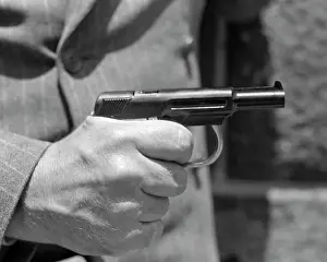 Man S: Man's Hand Holding Pistol Finger on the Trigger