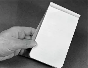 Flipped: Mans Hand Holding Small Note Pad
