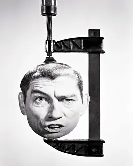 Clamp: Man's Head with Funny Facial Expression Being Squashed