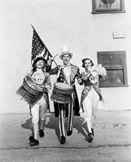 Cooperate: Marching band performing in a parade with an American flag