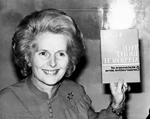 Aims: Margaret Thatcher holding up a book