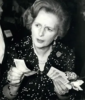 Handful: Margaret Thatcher with one pound notes at conference