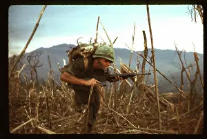 Quang: A Marine, under fire, runs for cover near the
