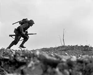 Offensives: Marine Pfc. Paul E. Ison runs through Japanese