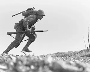 Offensives: Marine Pfc. Paul E. Ison runs through Japanese