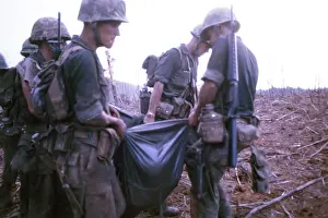 Quang: Marines carry a dead comrade in a poncho at the