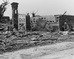 Offensives: Marines fire at Japanese snipers concealed in