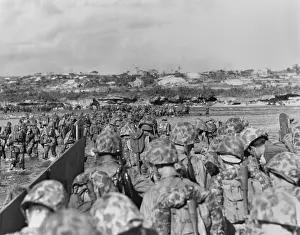 Offensives: Marines leave their landing craft to wade over